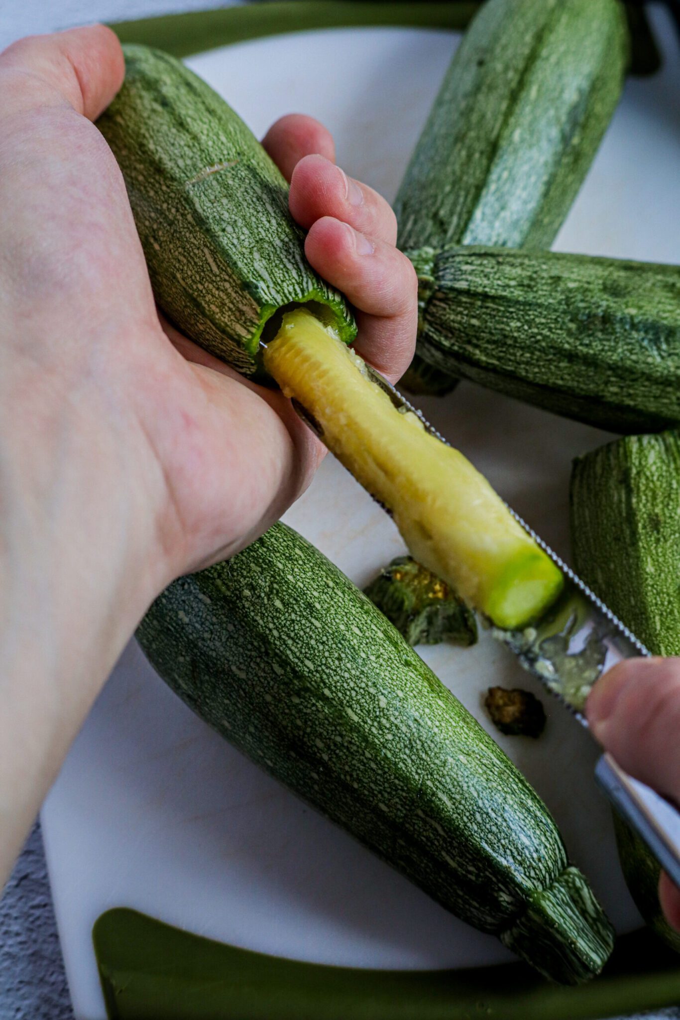 the flesh being removed from a mini zucchini