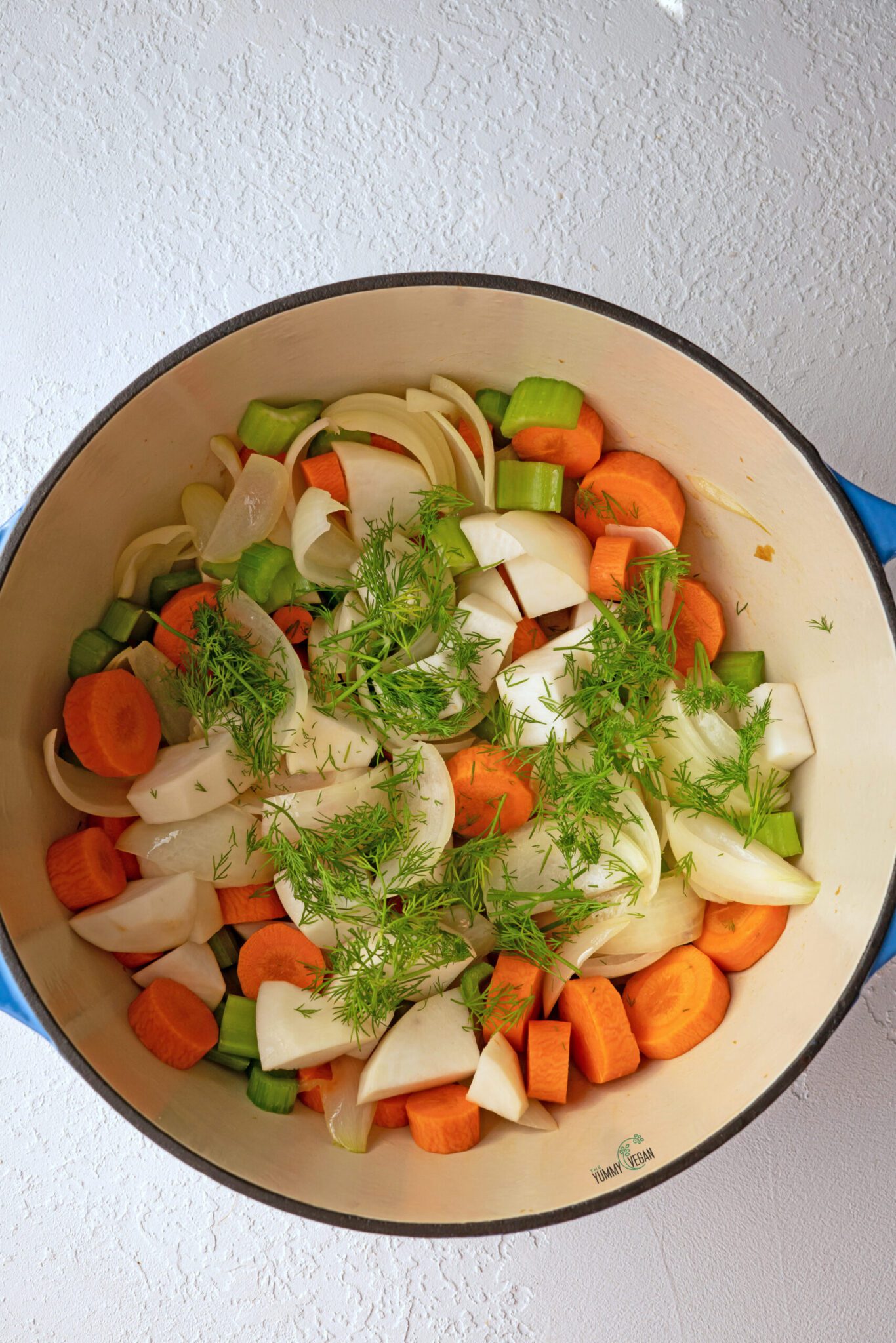 fresh dill added to the pot with veggies